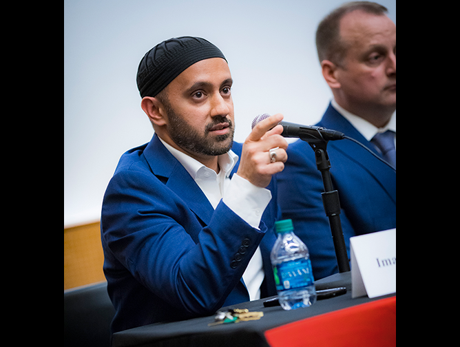 Imam Khalid Latif addresses a member of the audience